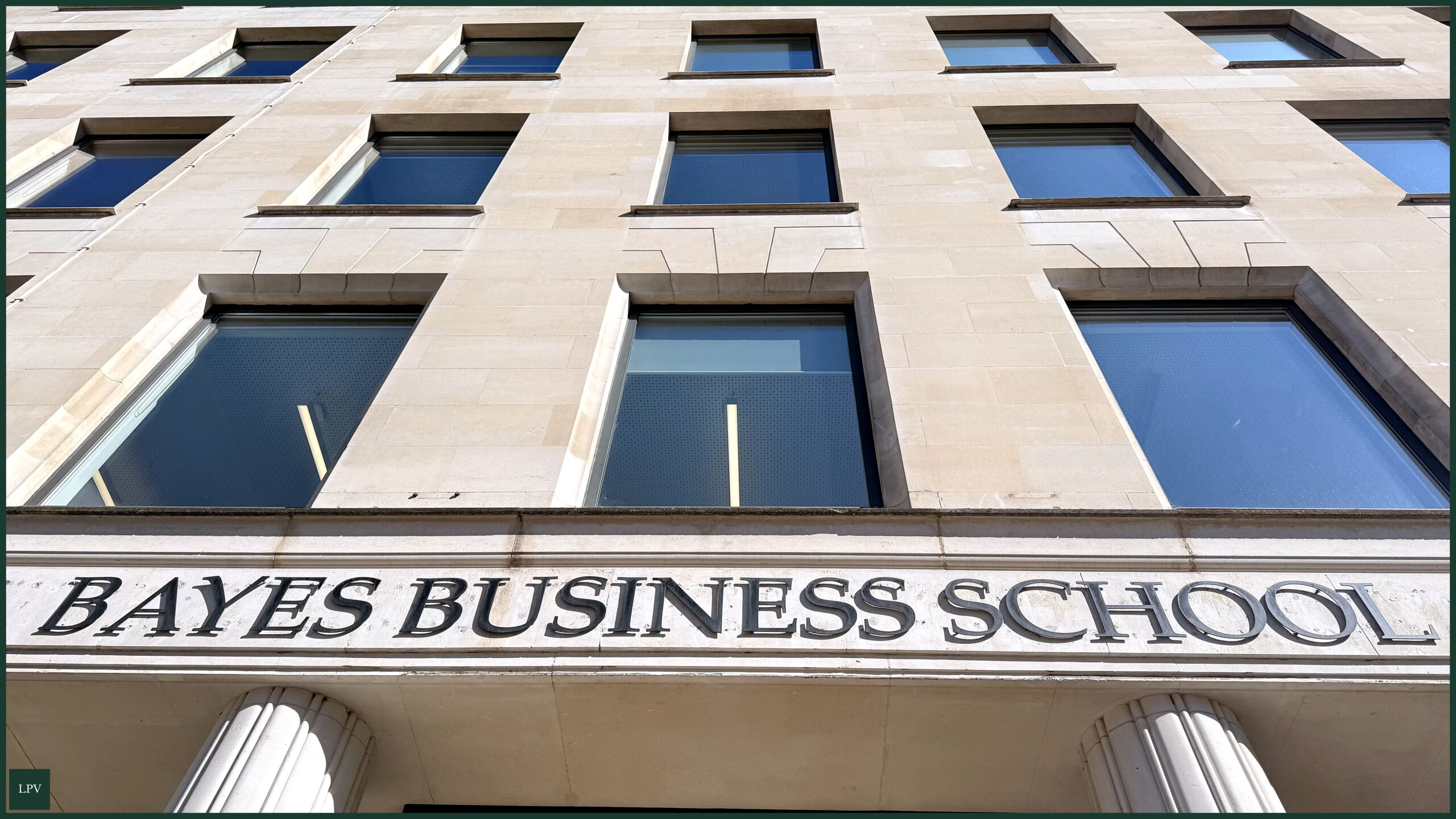 Group of professionals collaborating at Bayes Business School, focusing on impactful business strategies.