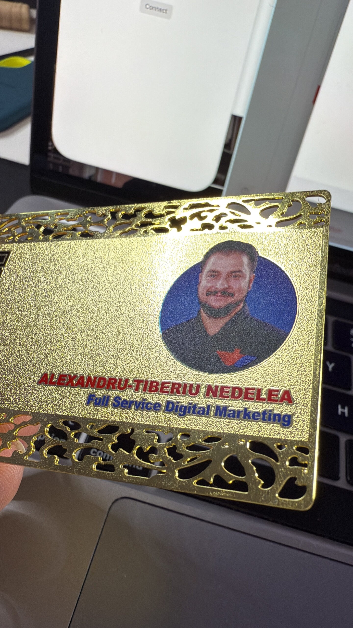 Gold ornate metal business card illustrating contrasting Dubai and London professional branding signals