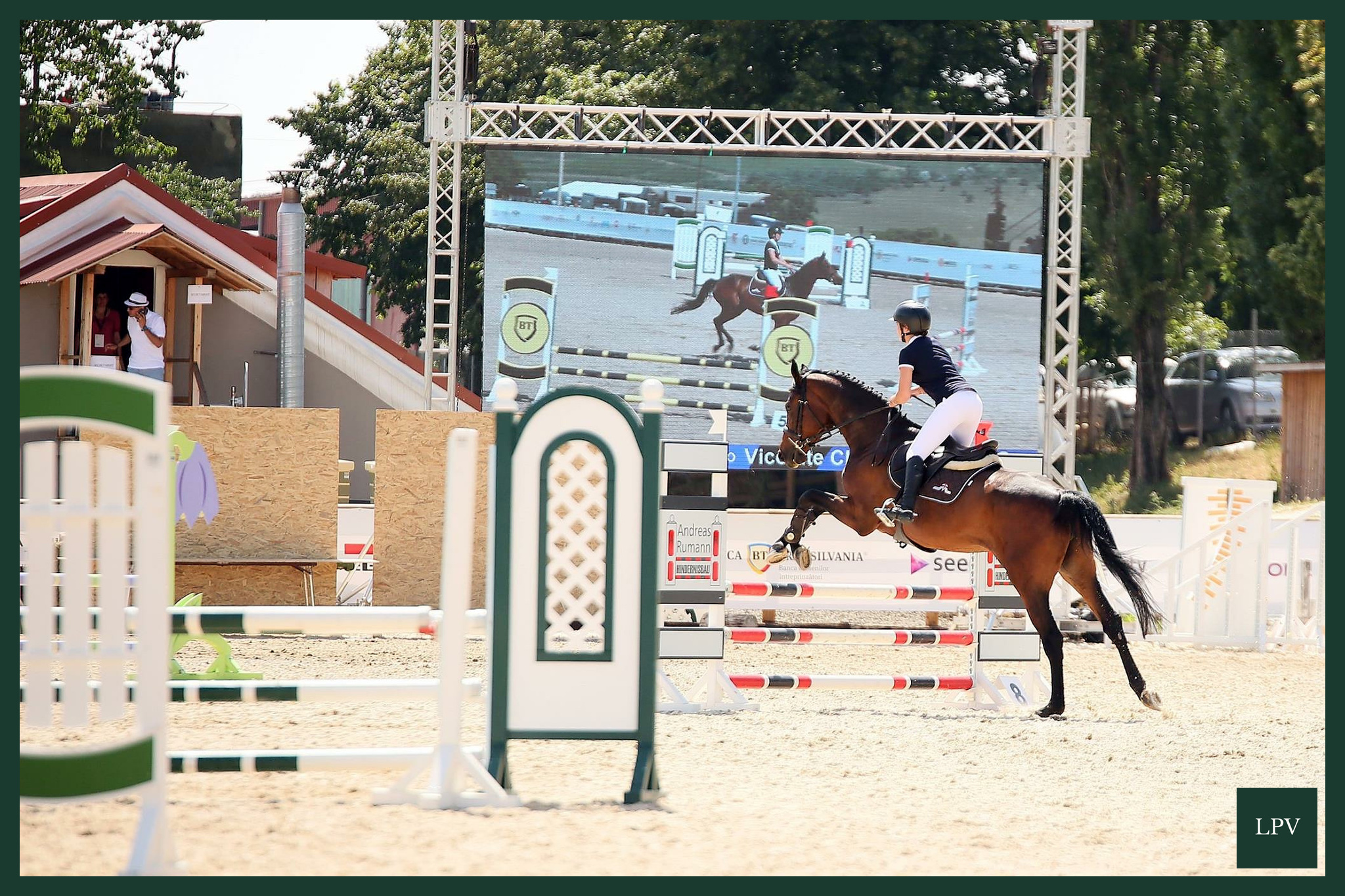 Horse jumping broadcast cameras and cables capturing split-second action for UK video marketing